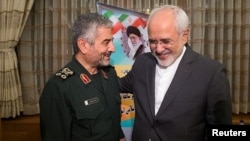 Islamic Revolutionary Guard Corps (IRGC) commander Mohammad Ali Jafari (L) and Iranian Foreign Minister Mohammad Javad Zarif smile during a meeting in Tehran, October 9, 2017