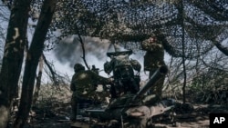 Ukrainian soldiers fire a cannon near the embattled city of Bakhmut in the Donetsk region on May 3.