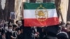Iranian students demonstrating against the government hold a flag that was used as the country's flag before the 1979 Islamic Revolution.
