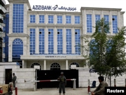 A policeman stands guard outside the main branch of Azizi Bank in Kabul. (file photo)