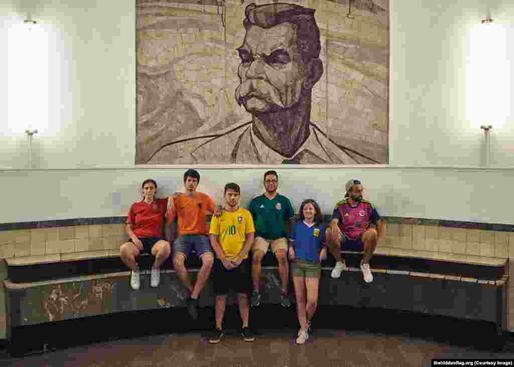 The group under a portrait of Soviet writer Maksim Gorky, in the Moscow subway.