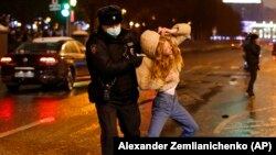 Riot police detain a young woman during a protest against the jailing of opposition leader Aleksei Navalny in Pushkin Square in Moscow on January 23.