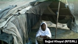 Zar Sanga sits outside her shelter in Pakistan's Khyber Pakhtunkhwa Province