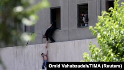 IRAN -- Two-year-old Emad is evacuated during an attack on the Iranian parliament in central Tehran, Iran, June 7, 2017. Omid Vahabzadeh/TIMA via REUTERS