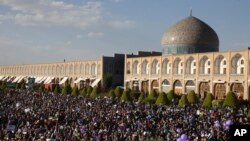 Supporters of Iranian President Hassan Rouhani in the May 19 presidential election attend his campaign rally, in front of the Sheikh Lotfollah Mosque, in Isfahan, Iran, Sunday, May 14, 2017. The election is seen largely as a referendum on Rouhani's outr
