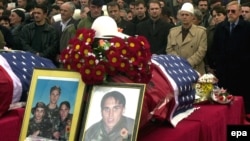 People in Pristina pay their last respects in 2002 to the three Bytyqi brothers who were killed in Serbia in 1999. 