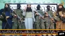 An image taken from a video released by a faction within the Pakistani Taliban on January 22, 2016 shows their leader Umar Mansoor (C) with militants delivering a statement from an undisclosed location.