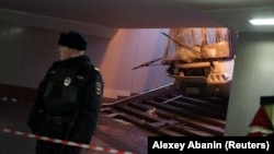 A Russian police officer attends the scene of a crash involving a passenger bus in a Moscow underpass on December 25. 