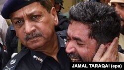 Ahsan Mehboob, Additional Inspector General of Police, comforts a relative of his comrade SP Mubarak Shah, who was killed by unknown gunmen in Quetta on July 13.