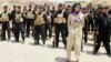 Kurdish pop star Helly Luv poses in front of Kurdish Peshmerga troops at a base in Dohuk.