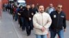 Suspected supporters of Fethullah Gulen are escorted by plainclothes police officers as they arrive at police headquarters in Kayseri in April 2017.
