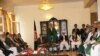 Afghan President Hamid Karzai (standing) speaks with members of the High Peace Council at its inauguration in Kabul, on October 7. One former Taliban leader describes the council as a good first step toward peace.