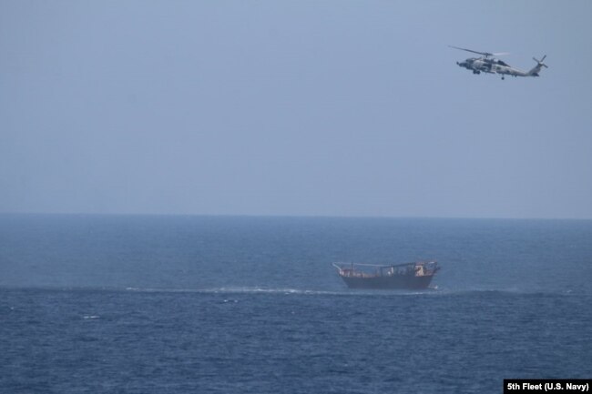 The dhow sailing vessel is shown as it is intercepted in the Arabian Sea.
