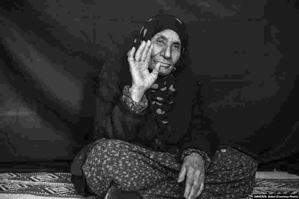 Salma, whose age is somewhere between 90 and 107 according to family members, poses for a portrait in Domiz refugee camp in the Kurdistan Region of Iraq on 15 December 2012. Salma fled her home in Qamishly City, Syria, at the beginning of December when the apartments surrounding hers were destroyed, arriving in Domiz ten days before this photograph was taken. She escaped with her three sons and their families, leaving home in the middle of the night in a rented car. The most important thing that she was able to bring with her is the ring she displays in this photograph. When she was ten years old, her mother gave it to her from her death bed, saying, &quot;Keep this ring and remember me.&quot; She intends to wear the ring to her grave. &quot;It&#39;s not valuable &ndash; not silver, or gold &ndash; just an old ring. But it&#39;s all that I have left.&quot; 