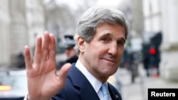 U.K. -- U.S. Secretary of State John Kerry waves as he leaves Number 10 Downing Street in London, 25Feb2013