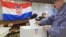 Croatia -- A man casts his ballot at a polling station in Zagreb, 22Jan2012
