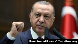 Turkey -- Turkish President Tayyip Erdogan addresses lawmakers from of his ruling AK Party during a meeting at the parliament in Ankara, October 30, 2019