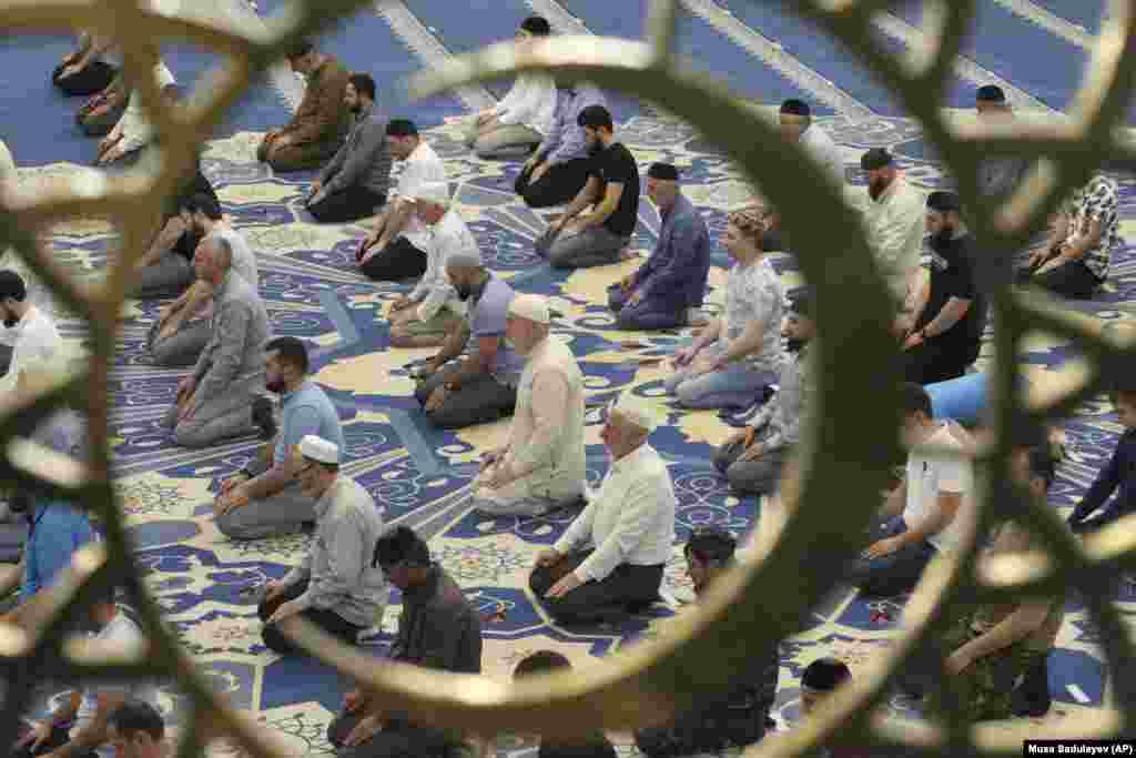 Chechen Muslims pray in a mosque on the first day of Eid al-Adha in the Russian republic&#39;s capital, Grozny, on July 20.