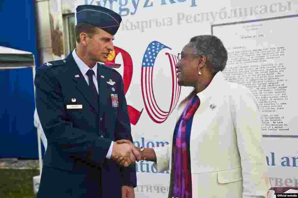 Col. Corey Martin shakes the hand of U.S. Ambassador Pamela Spratlen during a Independence Day celebration at the U.S. Embassy, Kyrgyzstan, July 3, 2012. Martin is the 376th Air Expeditionary Wing commander at the Transit Center at Manas, Kyrgyzstan. Spra