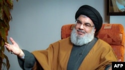 (FILES) A file handout picture obtained by AFP from the office of Iran's Supreme Leader Ayatollah Ali Khamenei on September 28, 2019, shows Lebanon's Hezbollah leader Hassan Nasrallah during what the office said was an "exclusive discussion" with members 