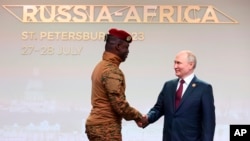 Burkina Faso's Captain Ibrahim Traore (left) and Russian President Vladimir Putin shake hands at the Russia-Africa Summit in St. Petersburg on July 27.