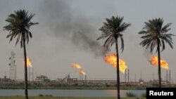 Flames emerge from burning excess gas from the oil fields in Basra. File photo