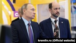 Vladimir Putin (solda) və German Klimenko