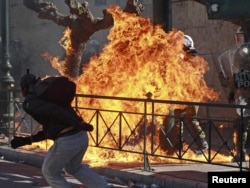 A youth throws a Molotov cocktail at police during riots in Athens last month. Will Rome be next?