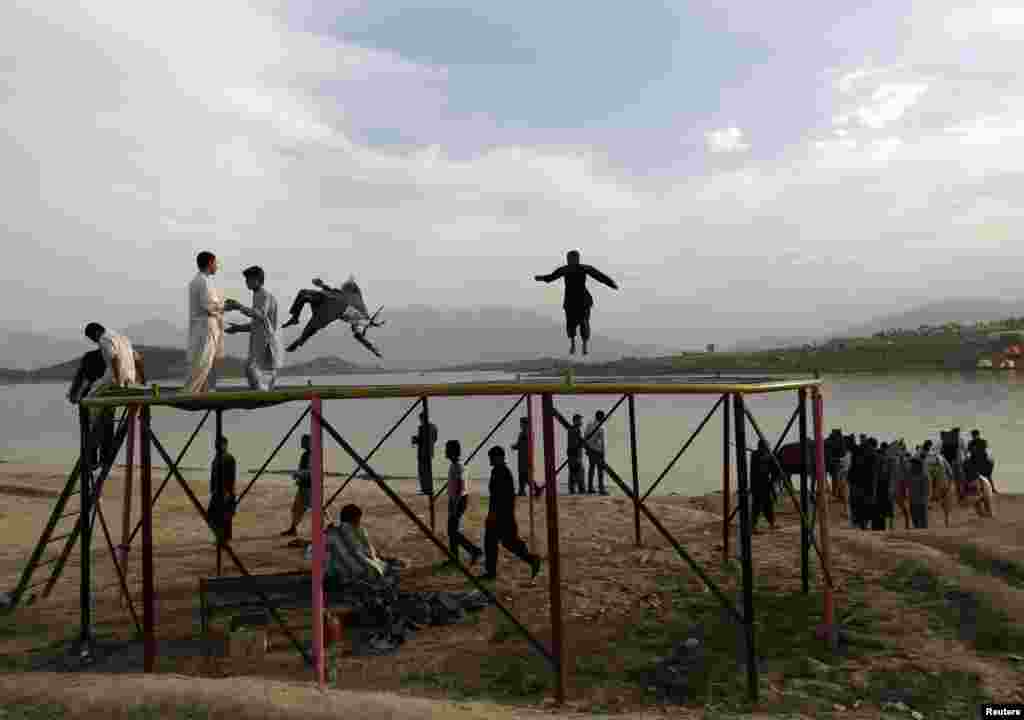 Afghans play on a trampoline along Qargha Lake on the outskirts of Kabul on April 28. (Reuters/Mohammad Ismail)