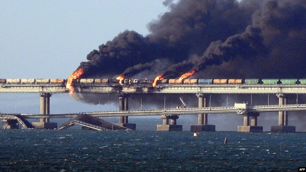 Footage shared on pro-Ukrainian social media showed a raging fire on the rail section of the dual road-and-rail Crimea Bridge over the Kerch Strait and a collapsed span on the nearby road segment.