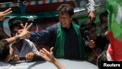 Imran Khan, chairman of the Pakistan Movement for Justice party (PTI) party, greets supporters after his visit to the mausoleum of Mohammad Ali Jinnah during an election campaign in Karachi earlier on May 7.