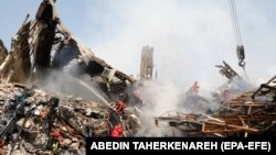 Rescue workers and fire fighters work at the site of the collapsed iconic Plasco building in Tehran, Iran, 20 January 2017. File photo