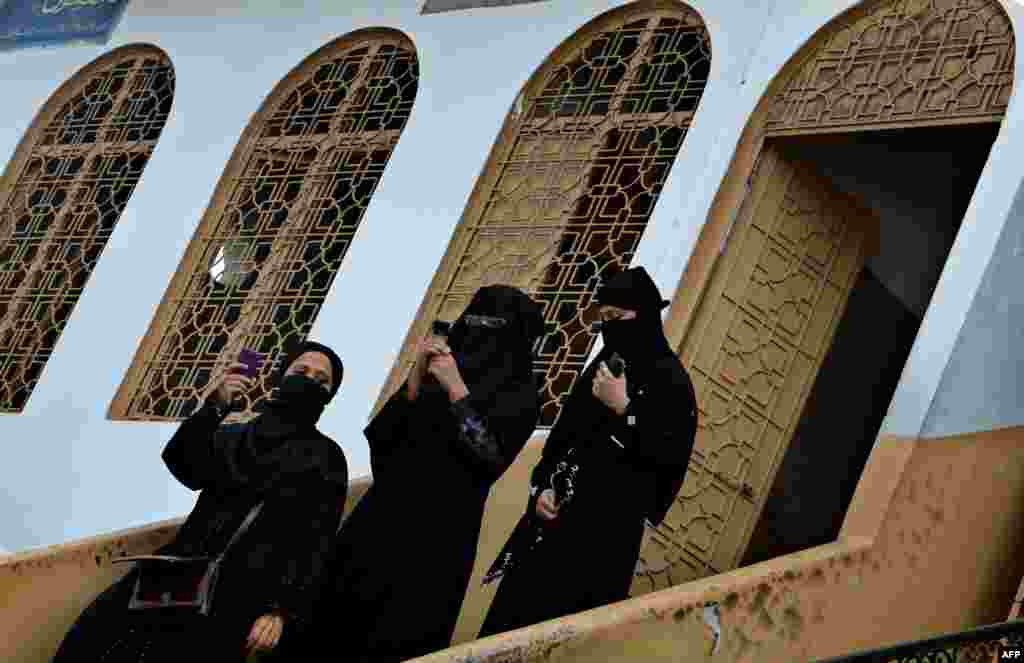 Teachers inspect the wreckage of a burned-out school in Lahore on November 3 after it was set on fire by an angry mob alleging that the school gave a test that insulted the Prophet Mohammed.