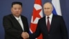 Russian President Vladimir Putin (right) and North Korean leader Kim Jong Un shake hands during their meeting at the Vostochny Cosmodrome in Russia's Amur region on September 13.