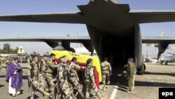 The coffin containing the body of a Spanish soldier in 2007 is carried by comrades to a military plane at the ISAF operations base in Herat, Afghanistan.