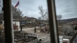 ARMENIA-AZERBAIJAN-KARABAKH-CONFLICT -- An Armenian soldier stands guard next to a road outside a house in the village of Shurnukh on March 4, 2021.