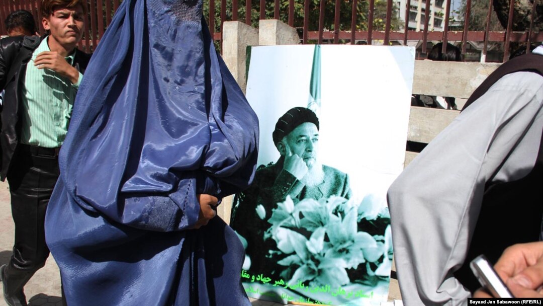 Supporters carry portraits of Burhanuddin Rabbani during a gathering in Kabul to remember him.