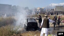 FILE: Pakistani firefighters extinguish a fire in a vechile at the site of a bomb explosion at a market in Parachinar, the main city in Kurram tribal district in December 2015.