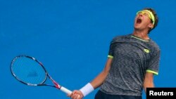 Uzbekistan's Denis Istomin celebrates after winning his men's singles match against Serbia's Novak Djokovic at the Australitan Open on January 19. 