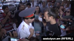 Armenia - Yerevan's Deputy Police Chief Valeri Osipian argues with a protester, Yerevan, 05Sep2013.