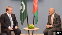 Pakistani Prime Minister Nawaz Sharif (L) speaks with Afghan President Ashraf Ghani during the BRICS/SOC emerging economies summit in the Russian city of Ufa in July 10.