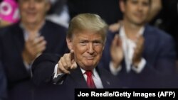 US -- TAMPA, FL - JULY 31: President Donald Trump gestures during his Make America Great Again Rally at the Florida State Fair Grounds Expo Hall on July 31, 2018 in Tampa, Florida. Before the rally, President Trump visited the Tampa Bay Technical High Sch