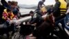 Migrants and refugees arrive on Sykamia beach, west of the port of Mytilene, on the Greek island of Lesbos after crossing the Aegean sea from Turkey on September 22.