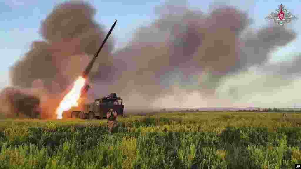 A Russian self-propelled multiple rocket launcher fires toward a Ukrainian position in eastern Ukraine.