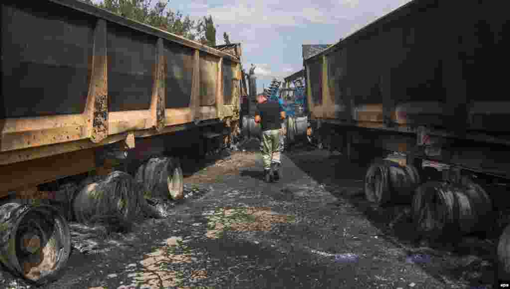 Locals inspect agricultural machinery damaged after shelling by pro-Russia separatists in the eastern village of Chermalyk, about 40 kilometers from Mariupol. (epa/Irina Gorbasyova)