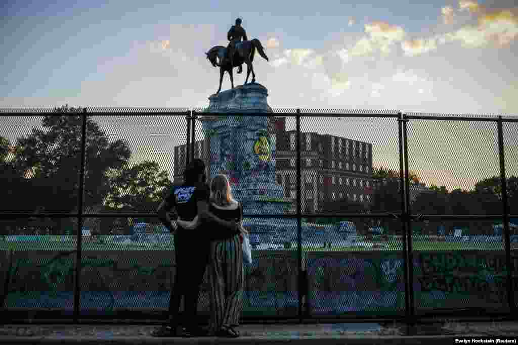 Egy richmondi pár nézi a szobrot, mielőtt elszállítanák
