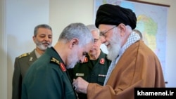 The commander of the Revolutionary Guards' elite Qods Force, Qassem Soleimani (left), receiving Iran's highest military award, the country's supreme leader announced Monday. March 11, 2019.