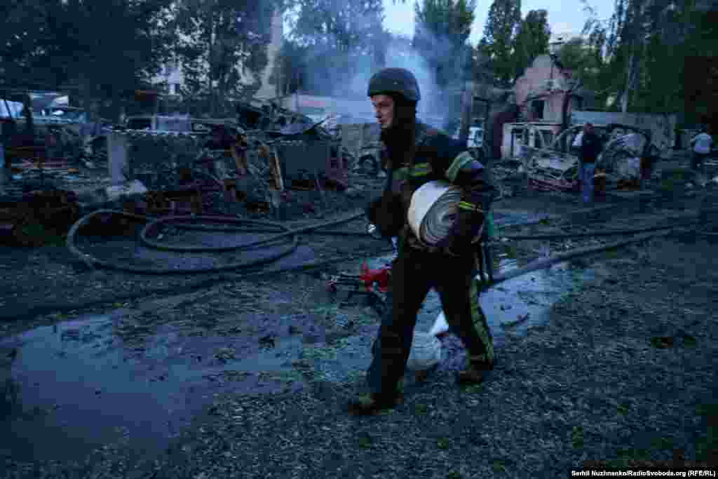 A firefighter at work extinguishing a blaze in Kyiv. Kyiv authorities say four people were killed in the Ukrainian capital during the overnight barrage. 