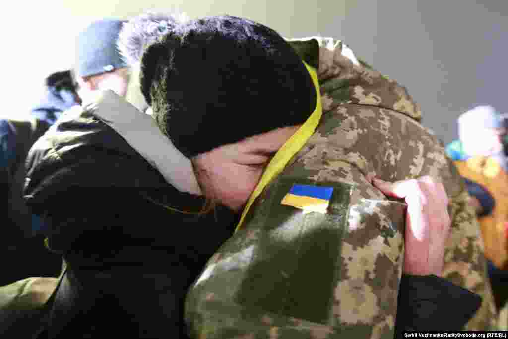 Ukrainian soldiers released by Russia-backed separatists in a prisoner swap are reunited with their loved ones at Boryspil Airport in Kyiv on December 28. (RFE/RL/Serhiy Nuzhnenko)&nbsp;