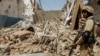 FILE: A Pakistani soldier stands near the debris of a house which was destroyed during a military operation in the town of Miran Shah in North Waziristan in July 2014.